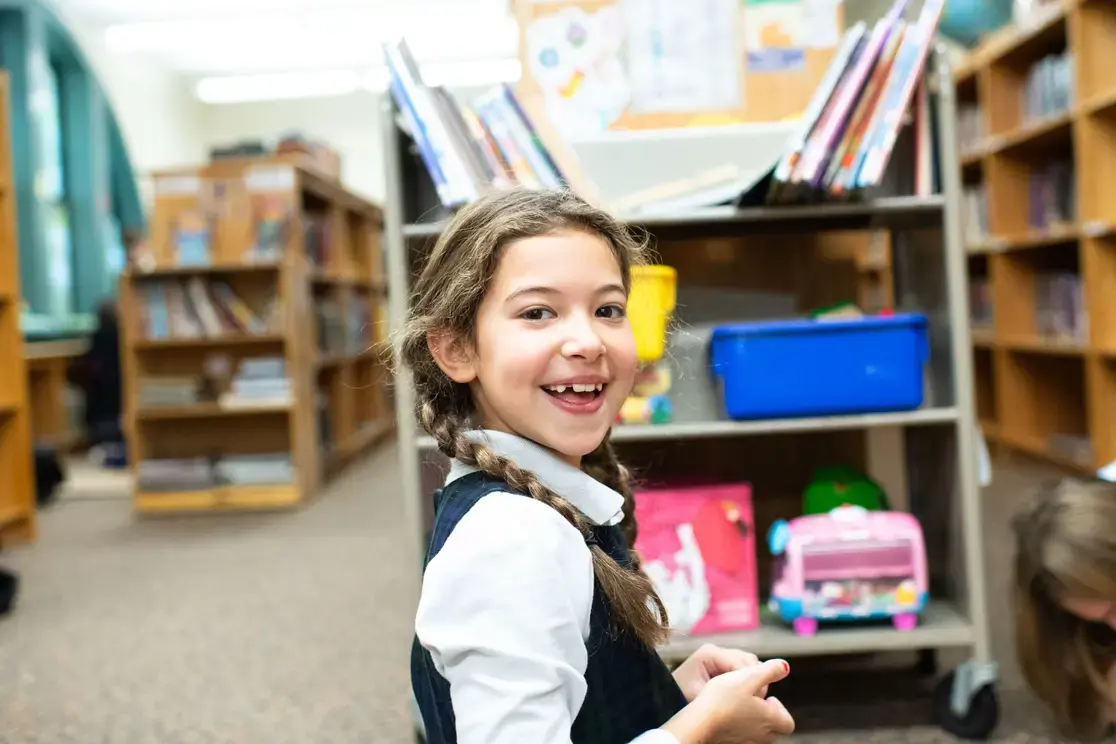 Student smiling in library