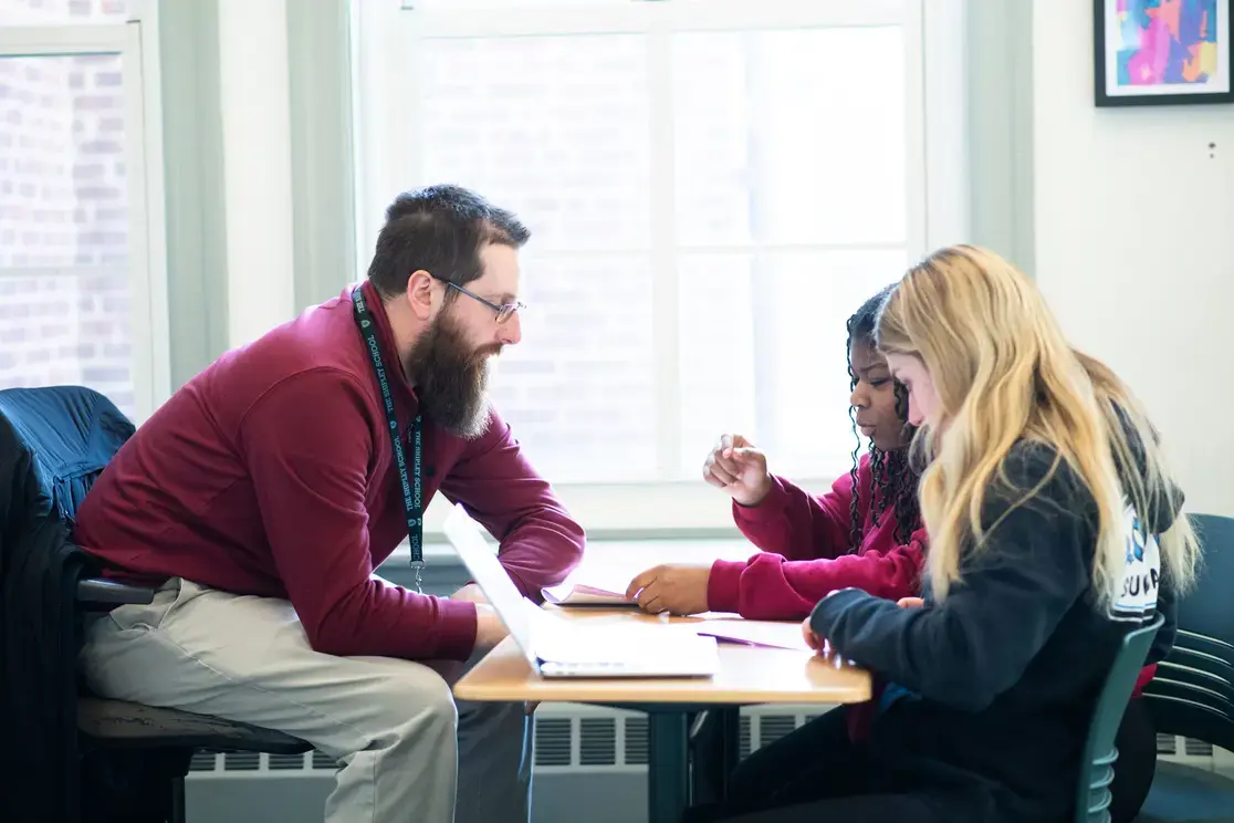 Teacher assisting students in class