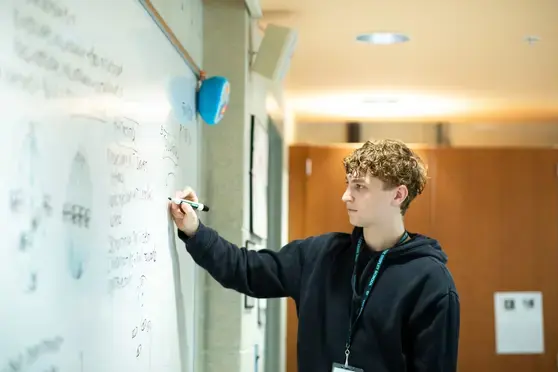 Teacher writing on whiteboard