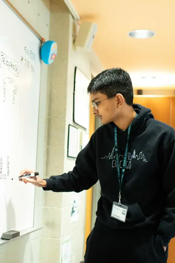 Student writing on whiteboard