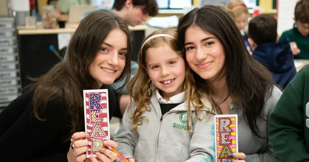 Upper and lower school students posing together