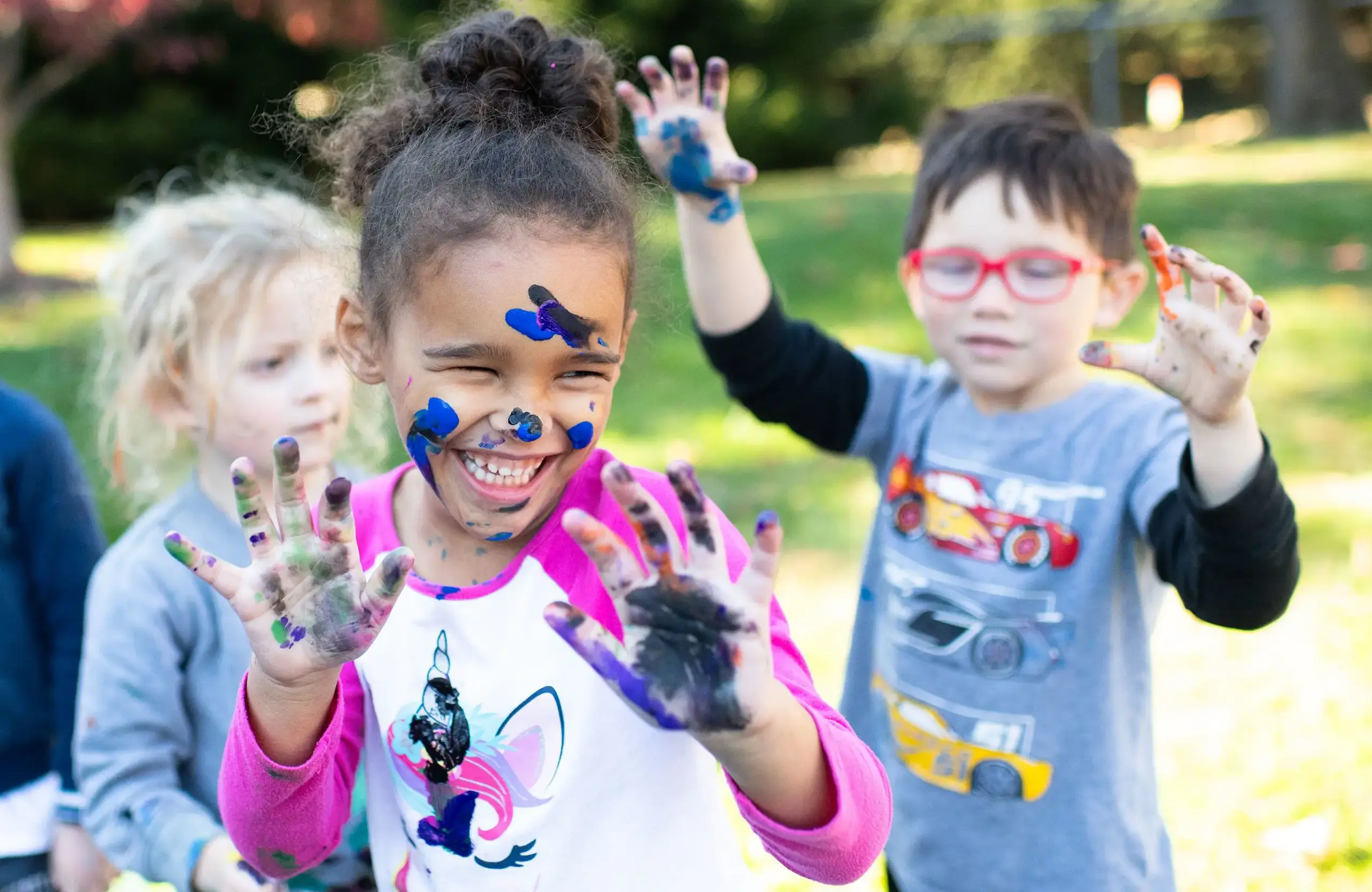 Lower school students playing with paint