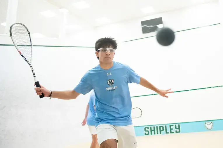 Student playing squash