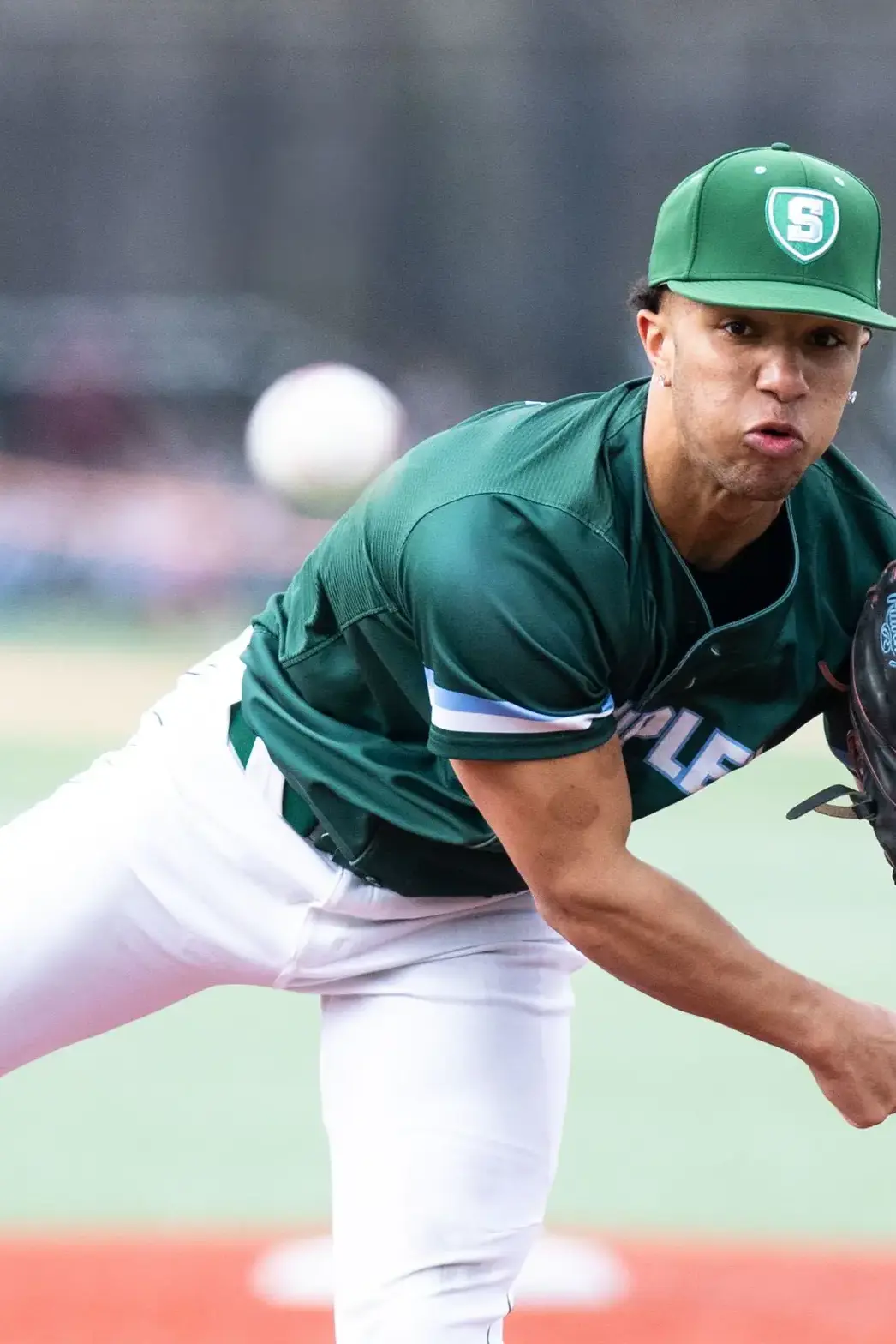 Student playing pitcher in baseball game