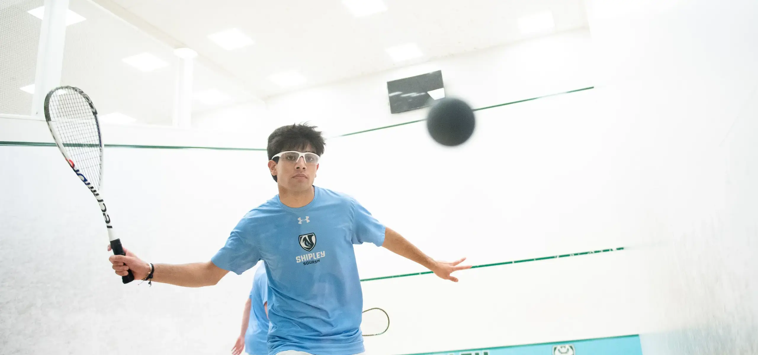 Student playing squash