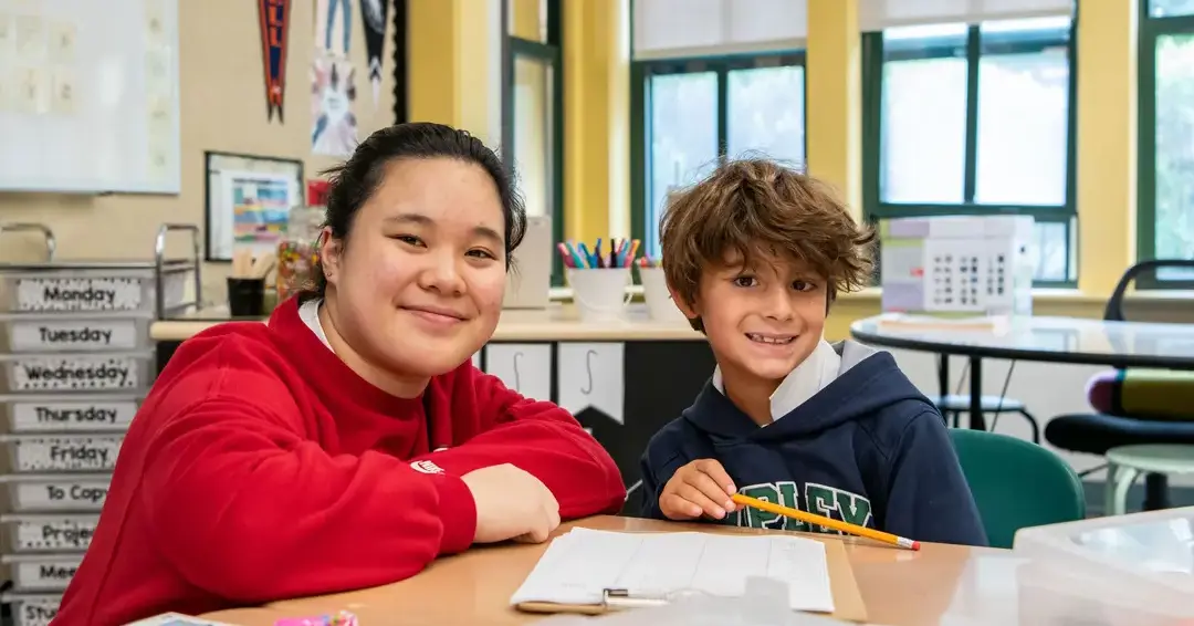 Student and teacher at desk