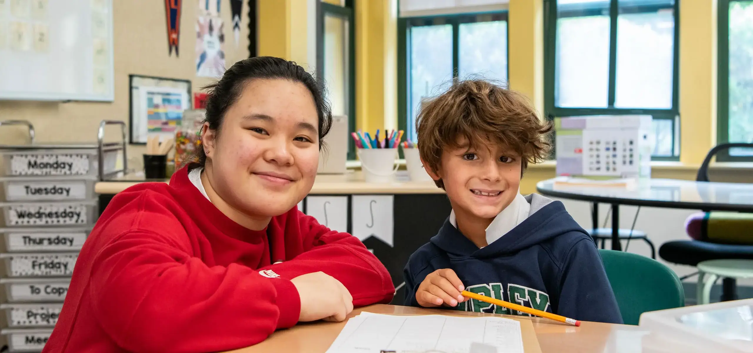 Students in class smiling