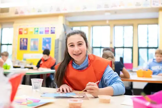 Student in art class smiling