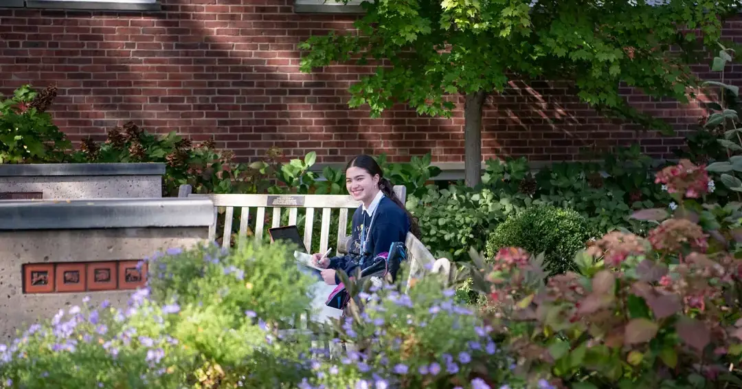 Student smiling in garden