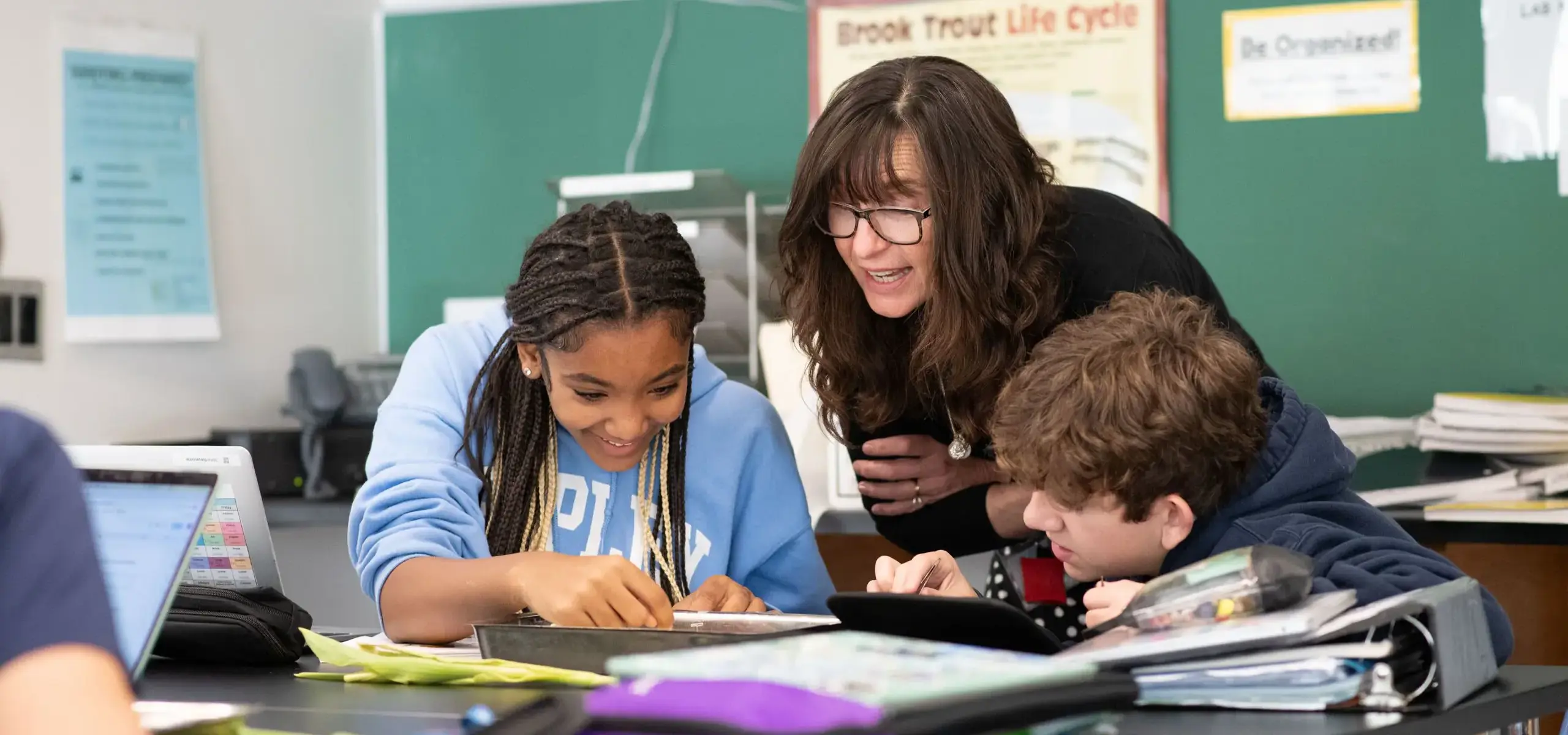 Teacher assisting student in class