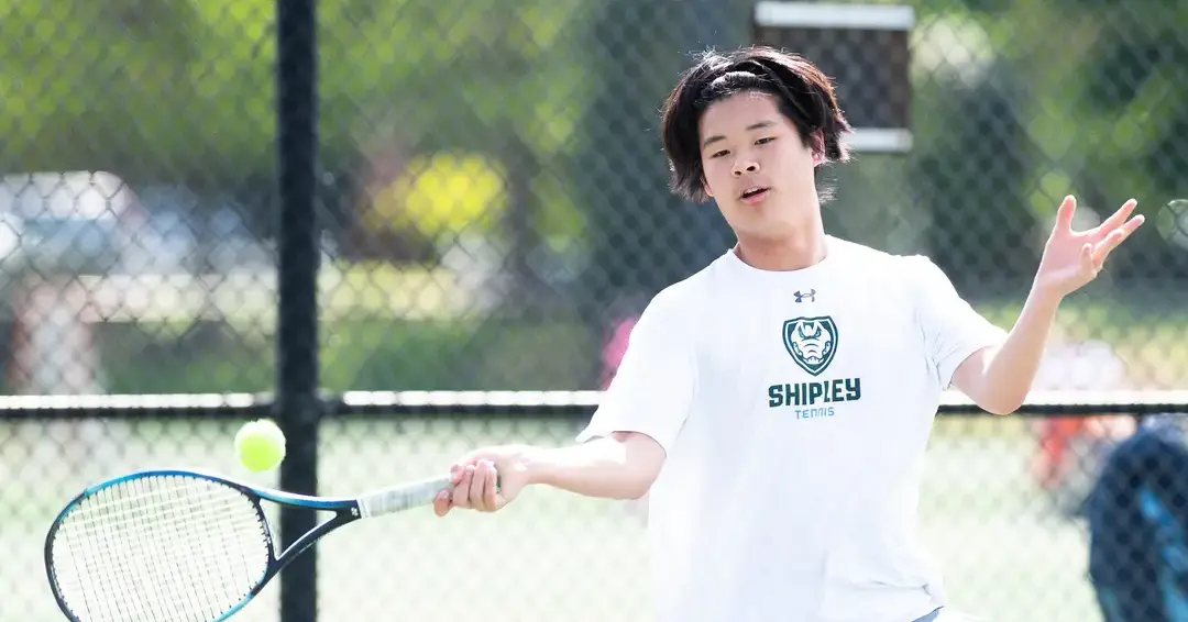 international student playing tennis