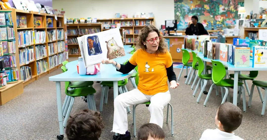 Teacher reading to students in library