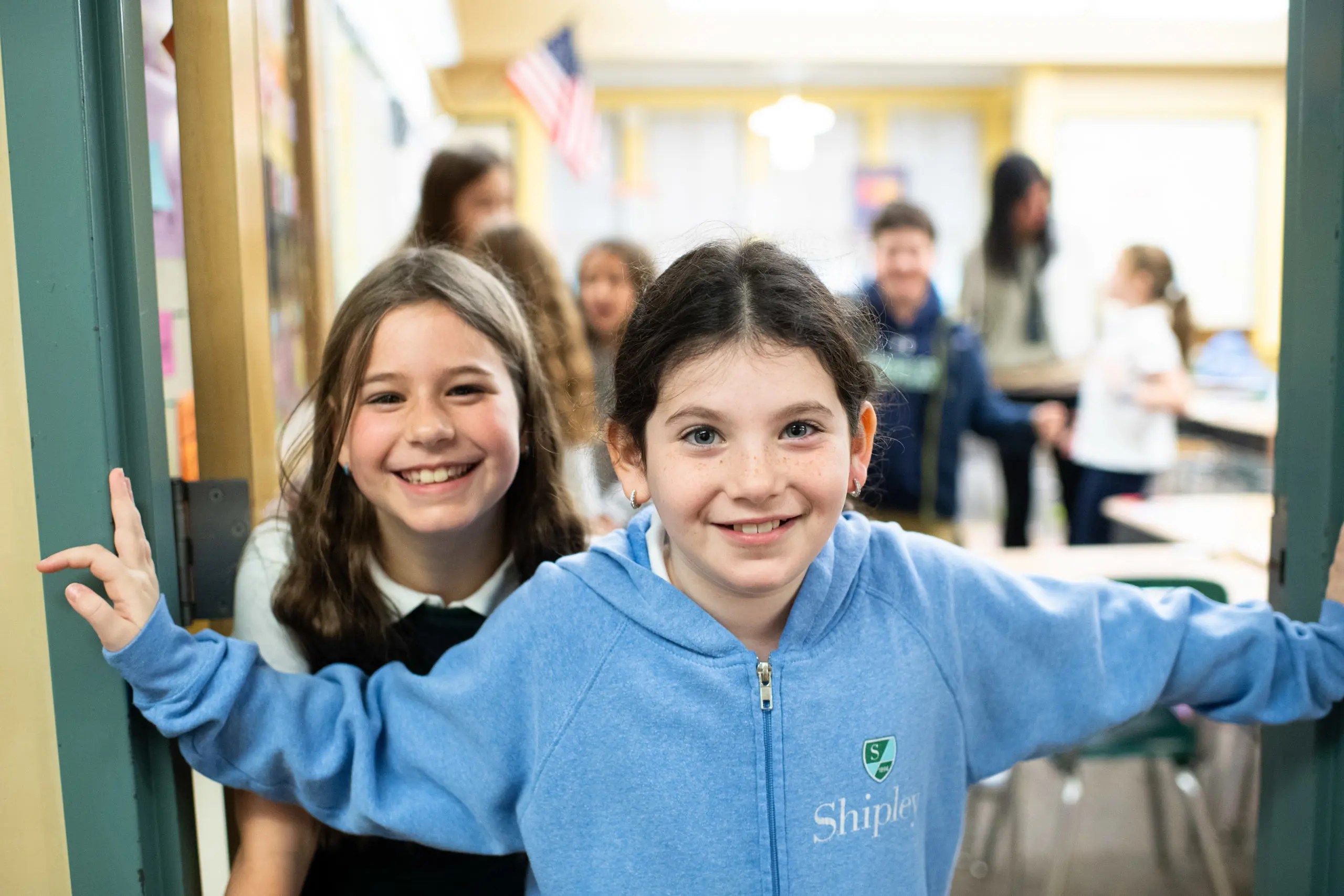 Lower school students in class smiling