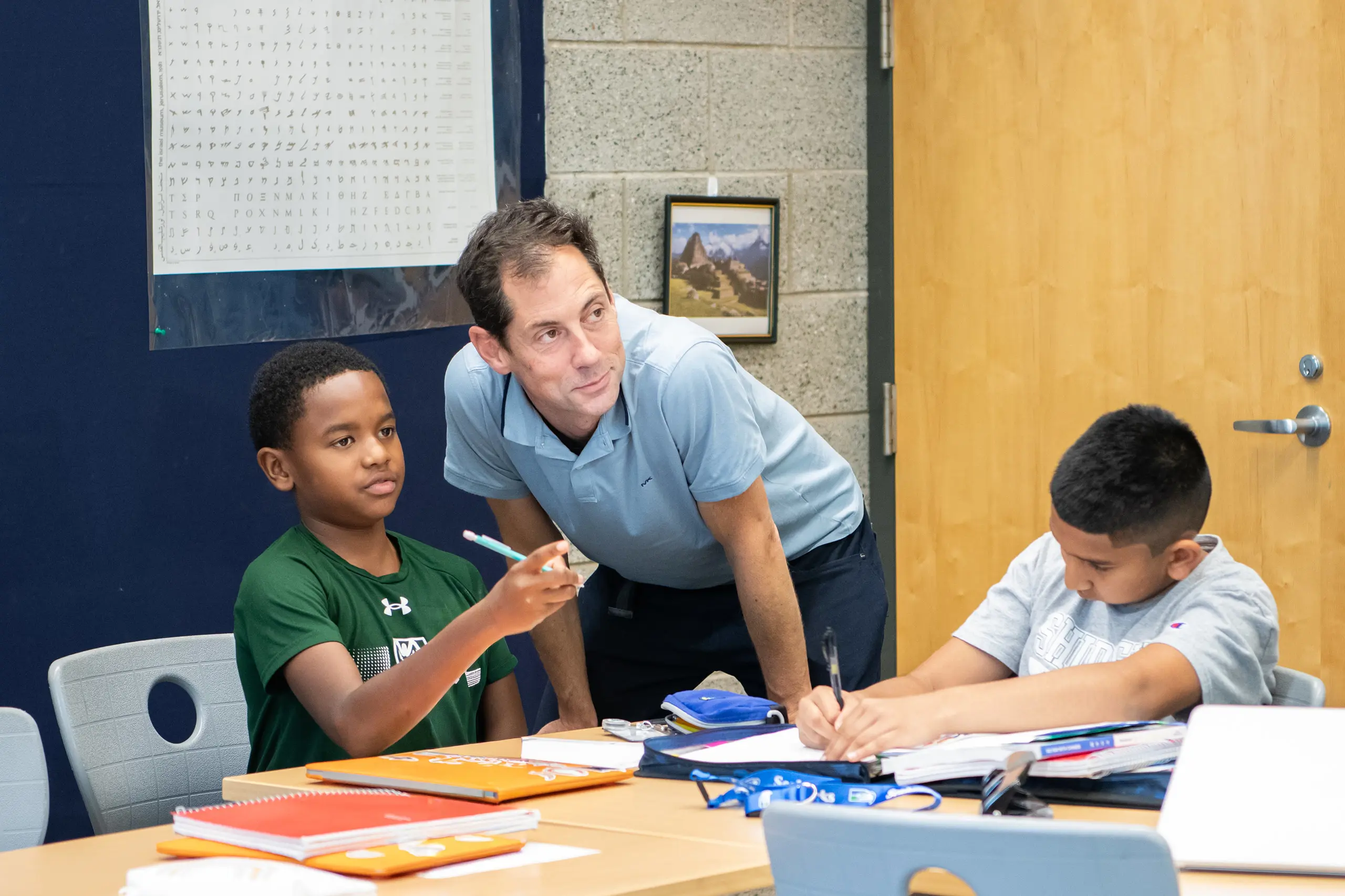 Student and teacher in class working together