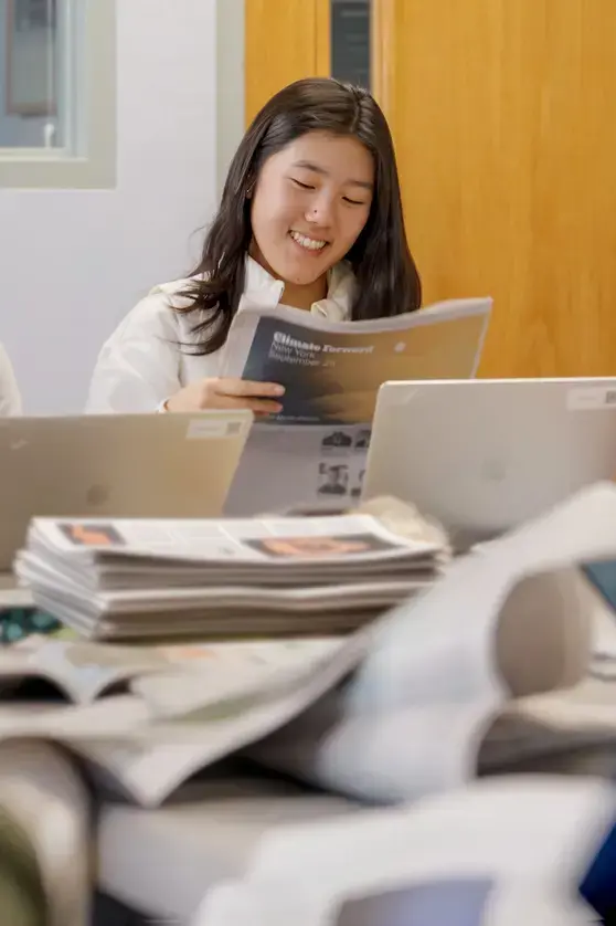 Student reading books and smiling