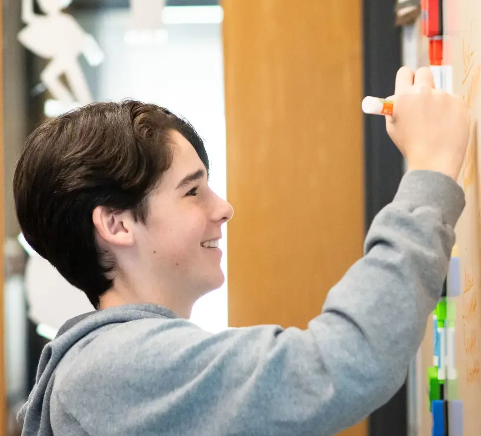 Student writing on board
