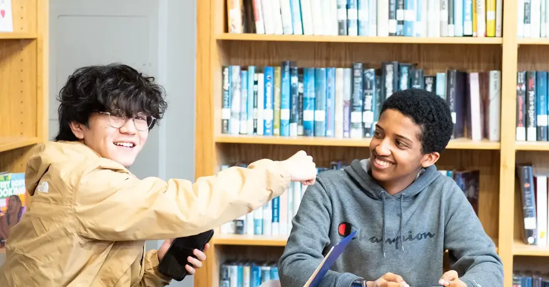 Upper school students in class chatting