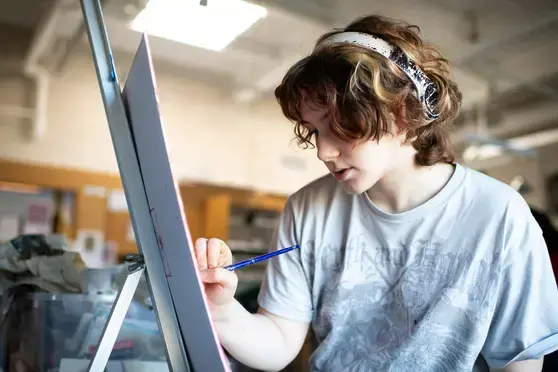 Student painting in art class
