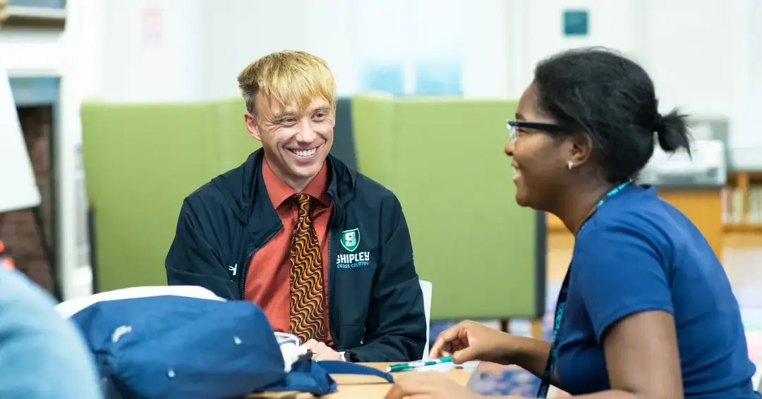 Teacher and student in class smiling