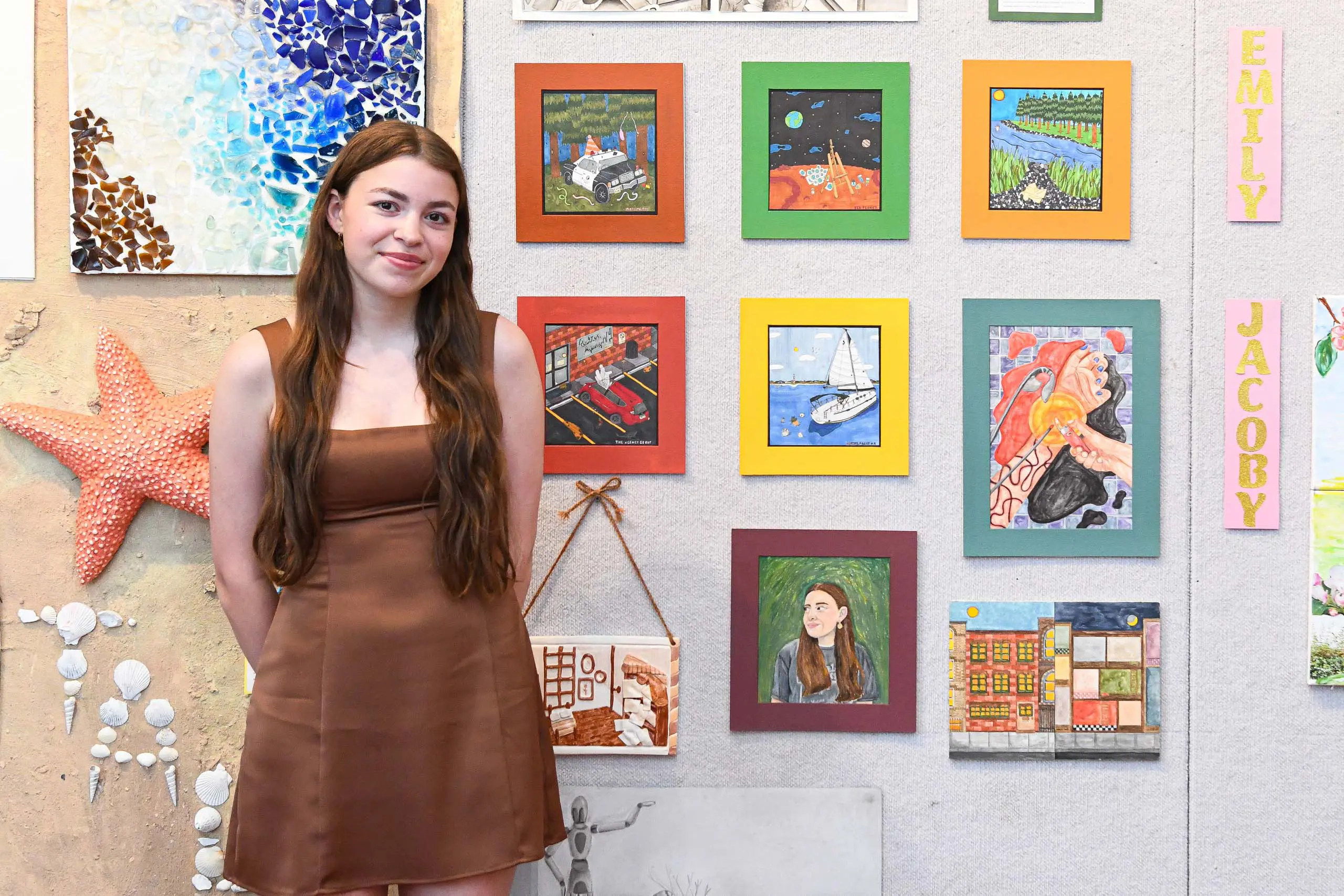 Upper school student in front of art work