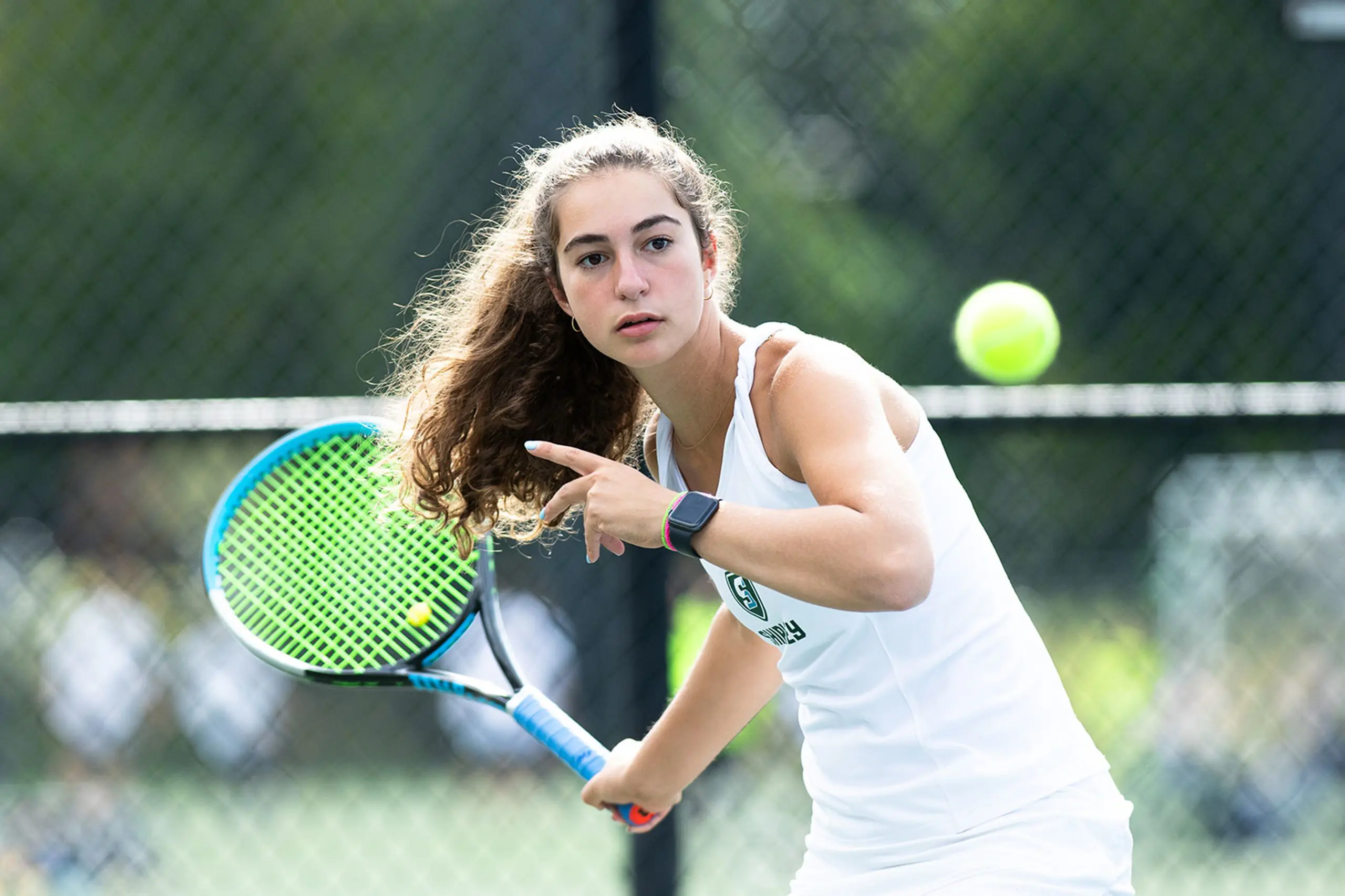 Student playing tennis