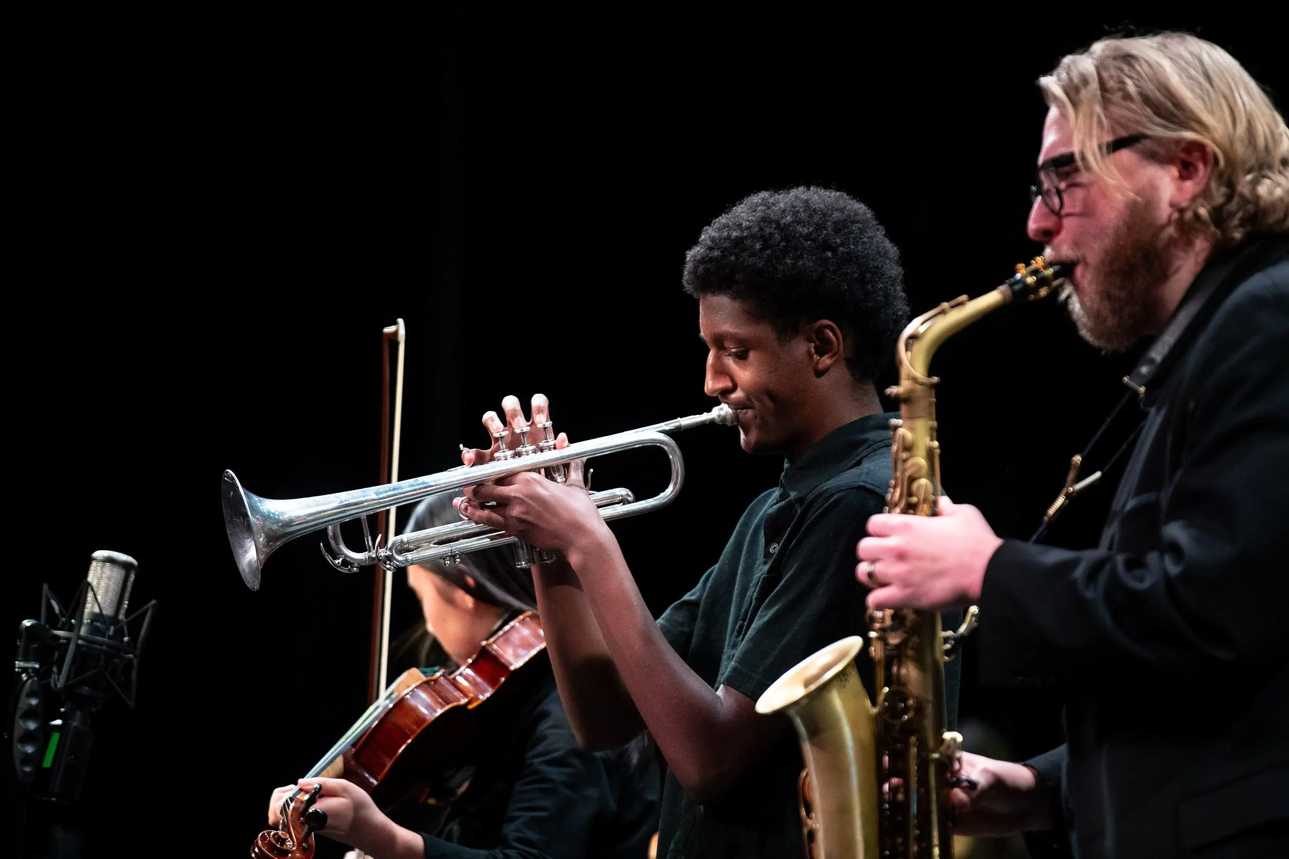 Student and teacher playing instruments