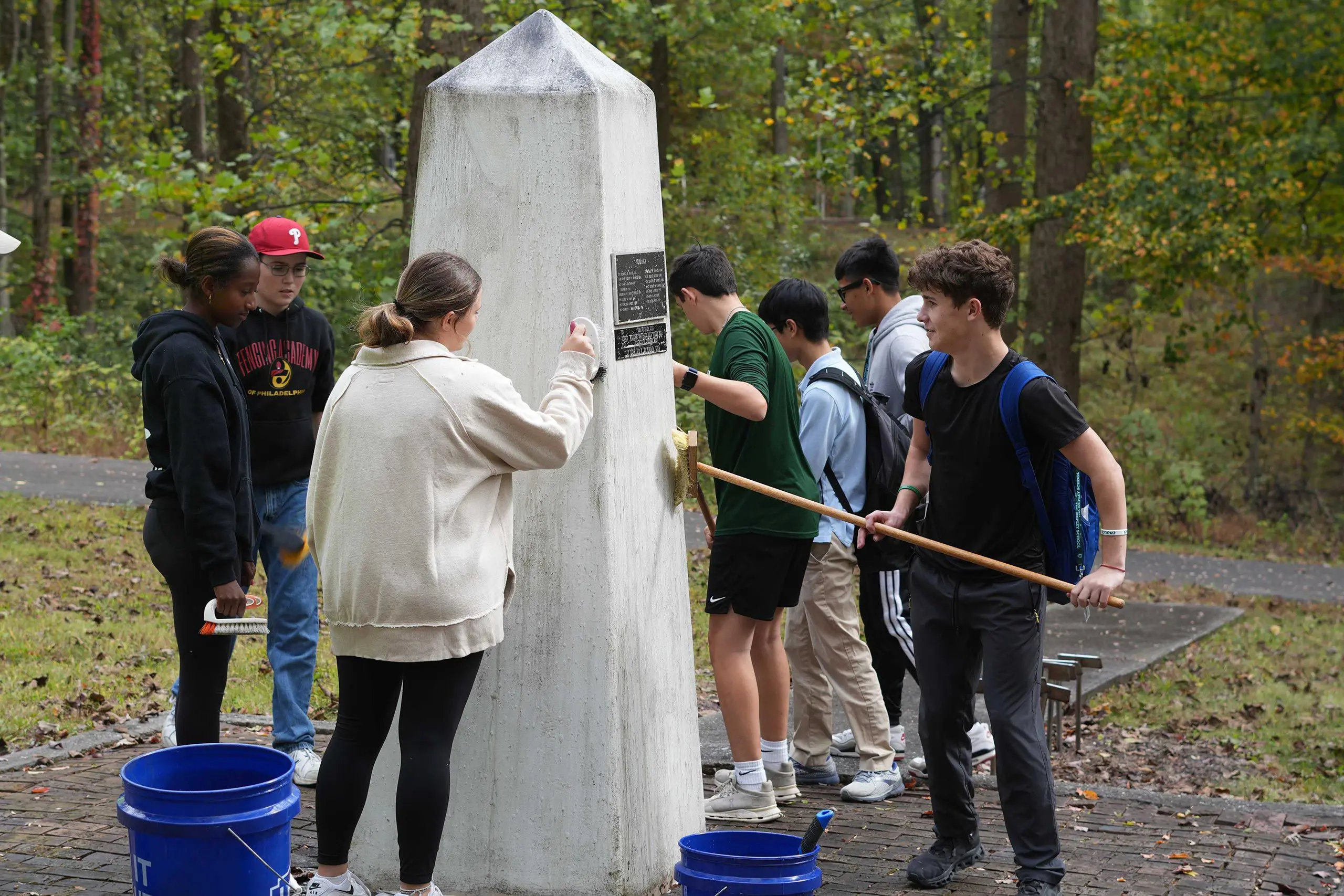 Students cleaning memorial