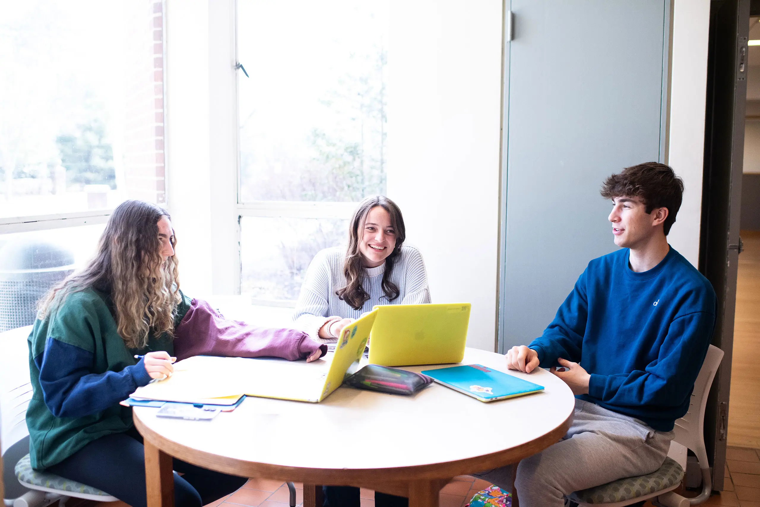 Students in class doing classwork on laptops