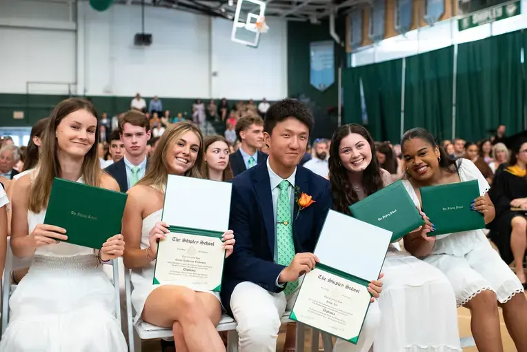 Students holding diplomas