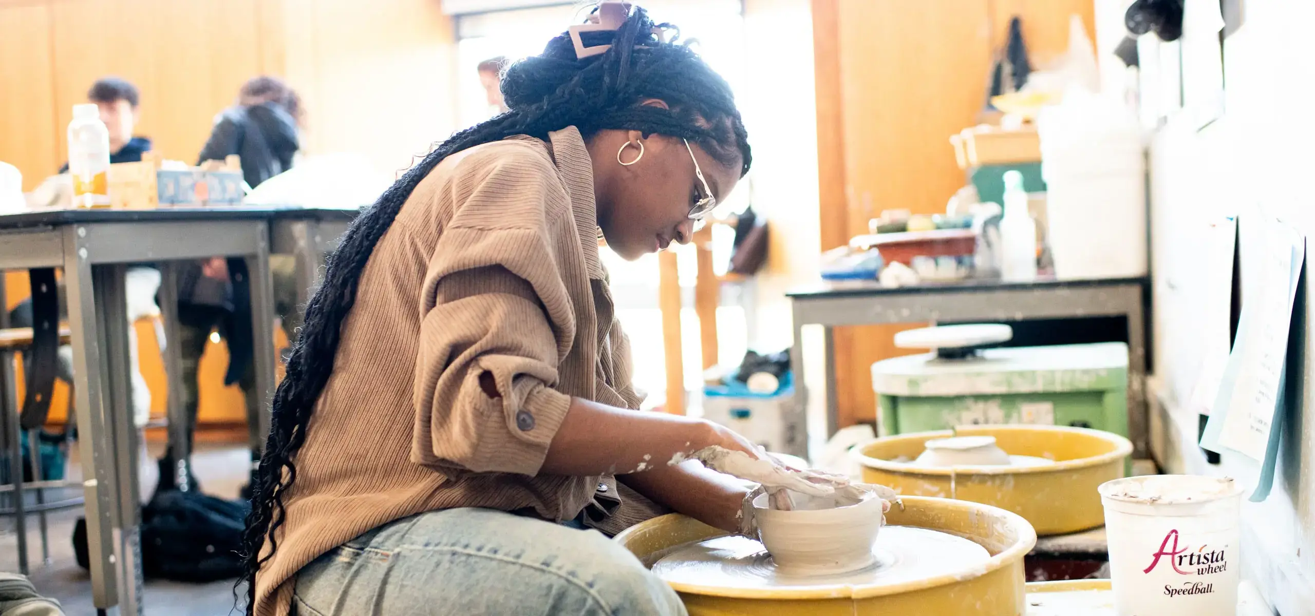 Upper school student in pottery class
