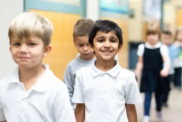 Students walking down school hallway