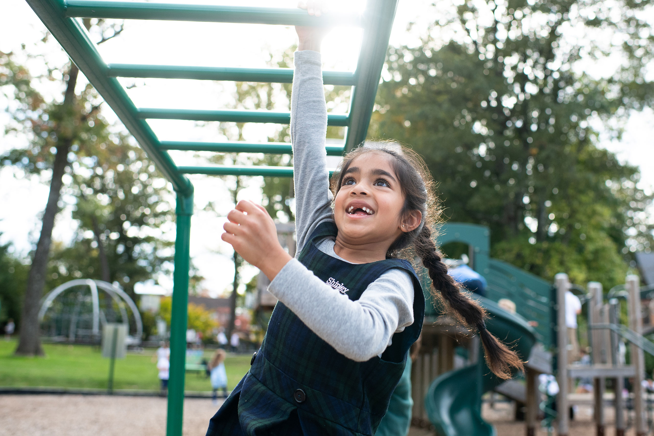 Student climbing on monkey bars