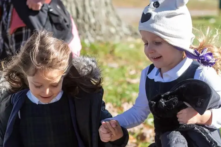 Students holding hands on field trip