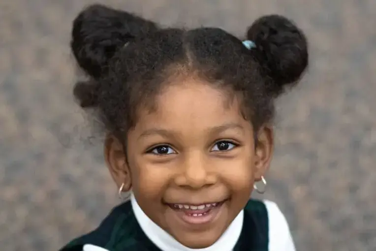 Student smiling up at camera