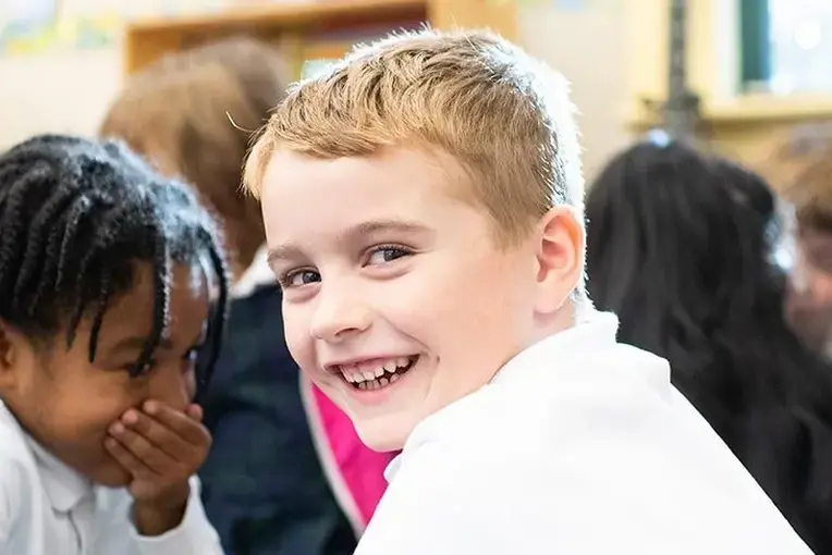 Student smiling and chatting with other students