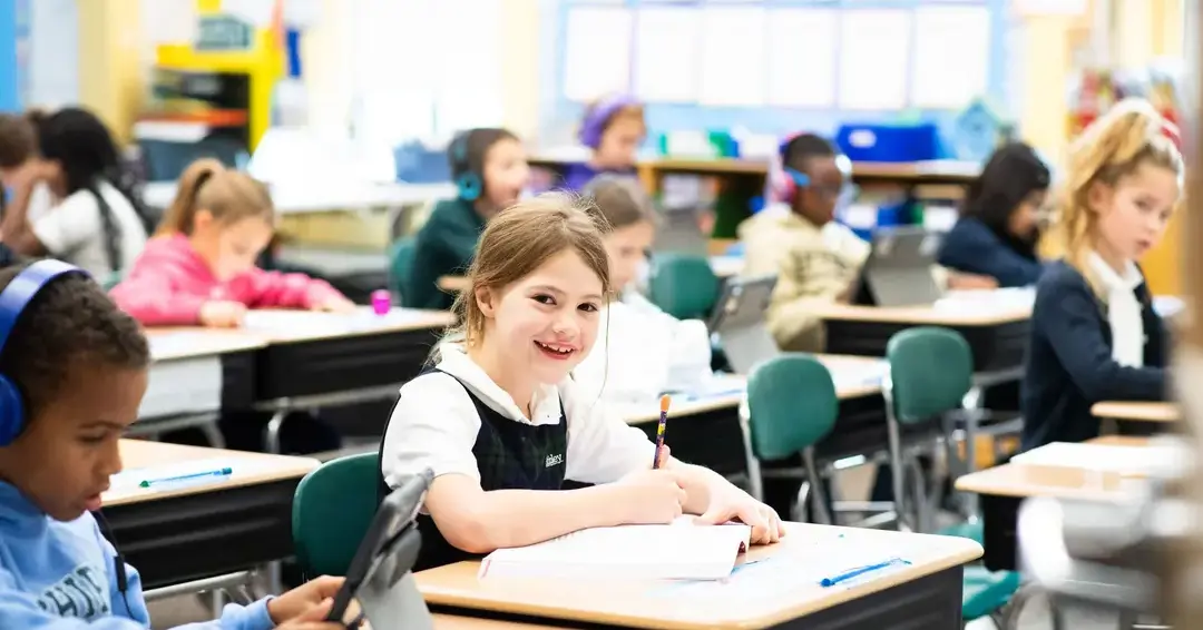 Student doing classwork and smiling