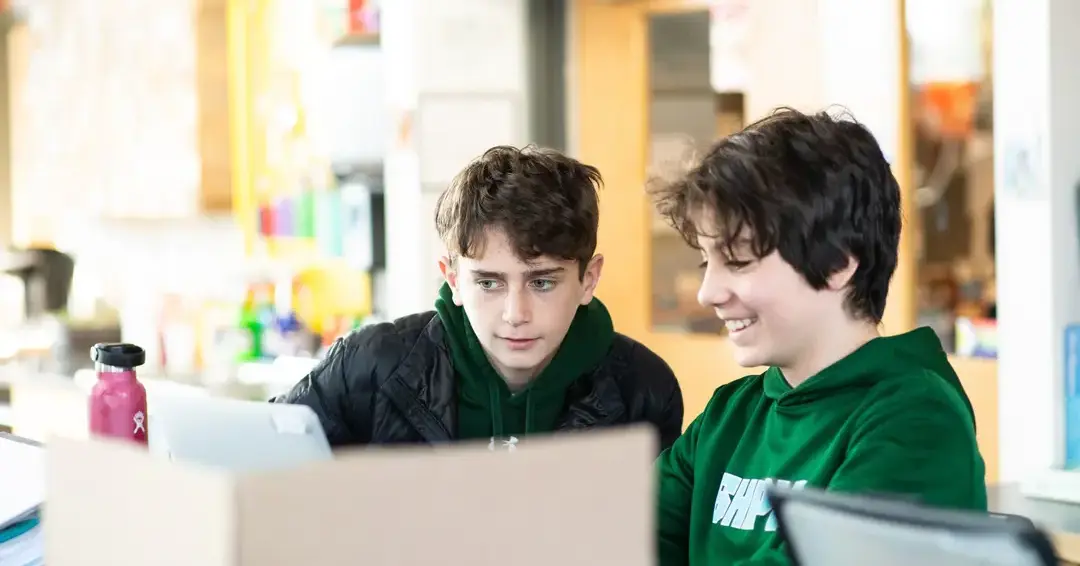 Students working on laptops together