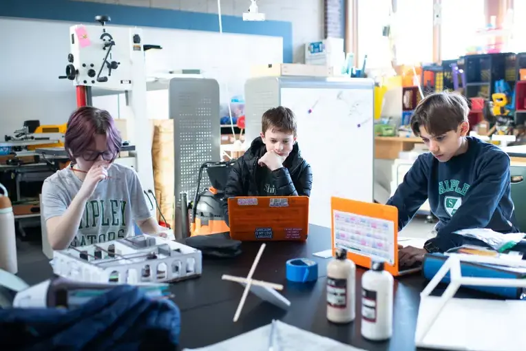 Middle school students in class collaborating