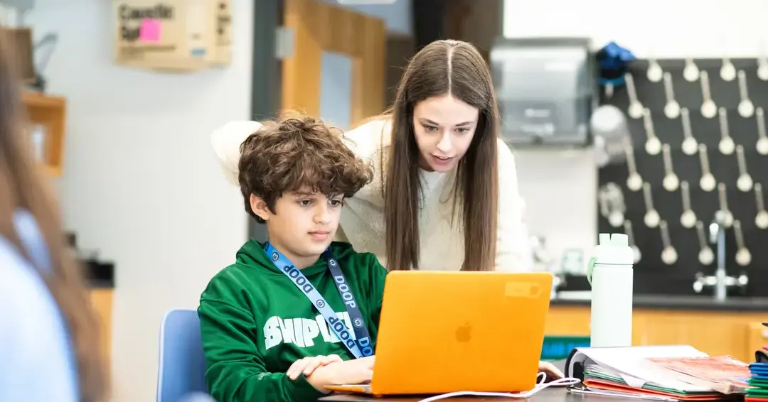 Students doing classwork on laptop together