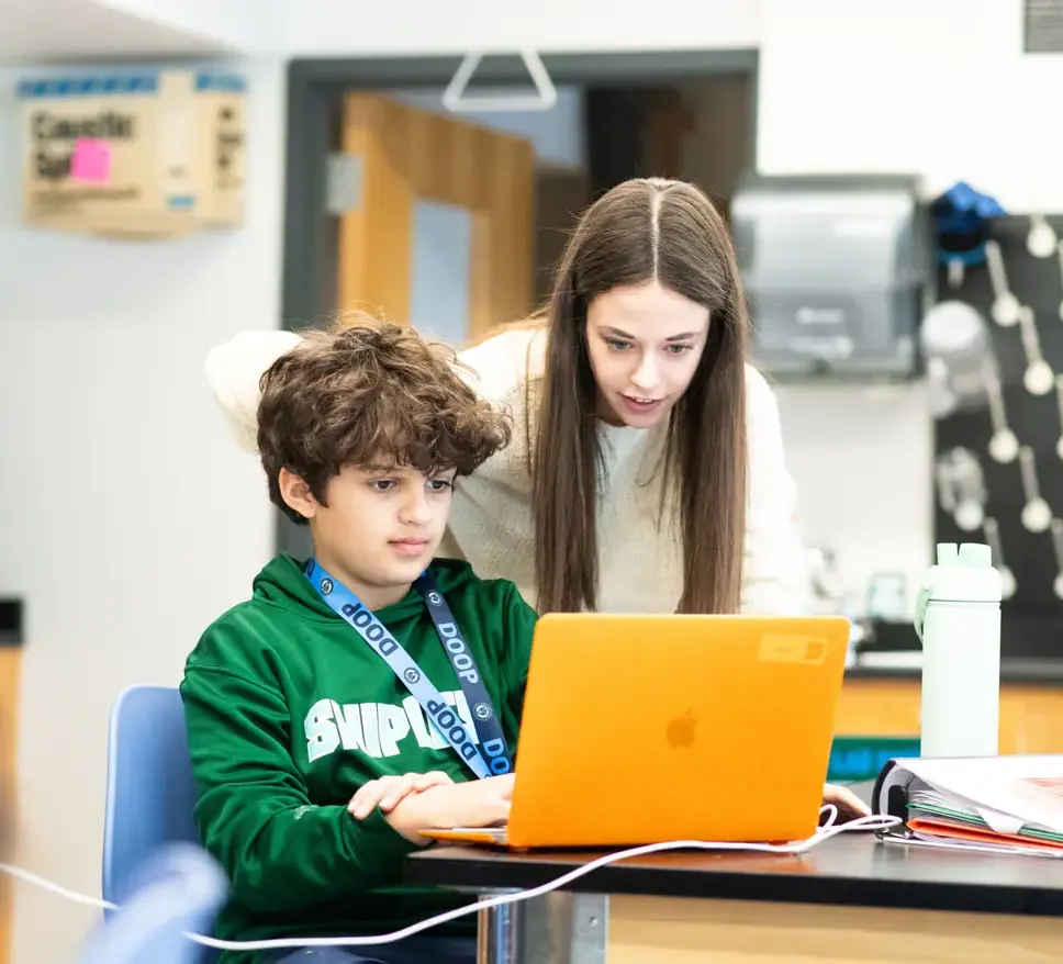 Teacher helping student