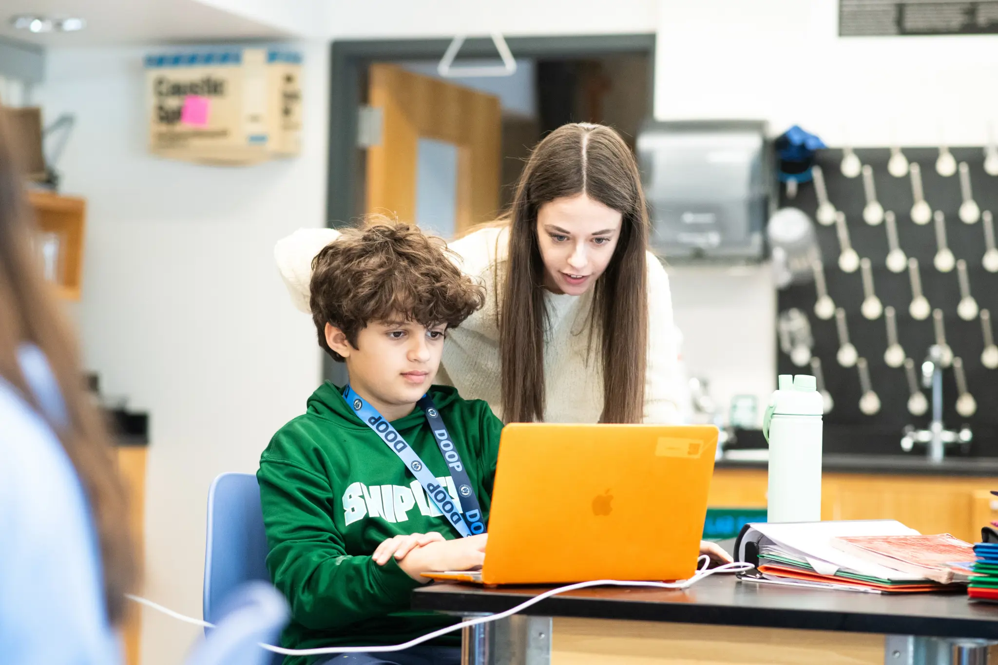 Teacher helping student