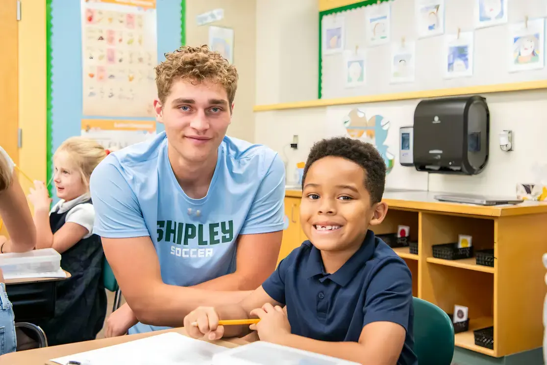 Upper school student helping lower school student
