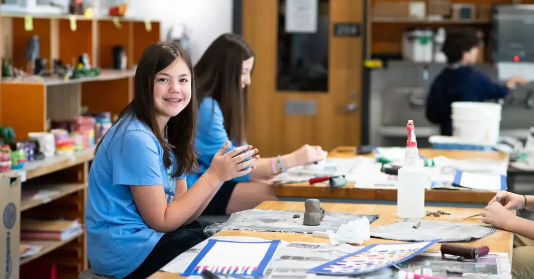 Student in art class smiling